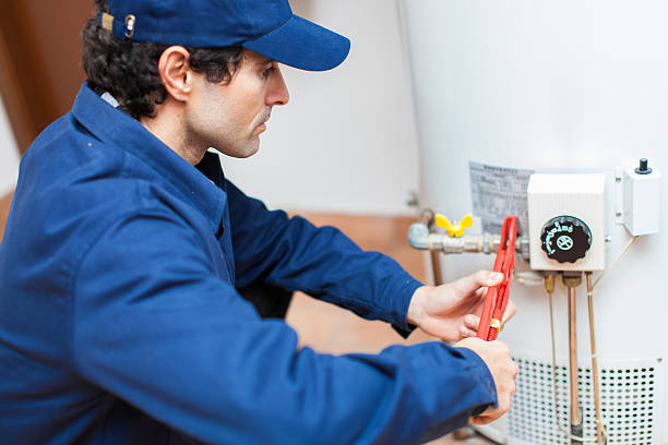 Plumber fixing an hot-water heater.